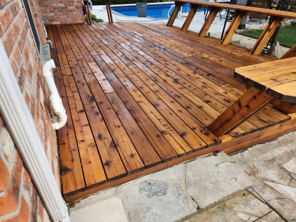 Deck after cleaning and staining, brick wall and steps
