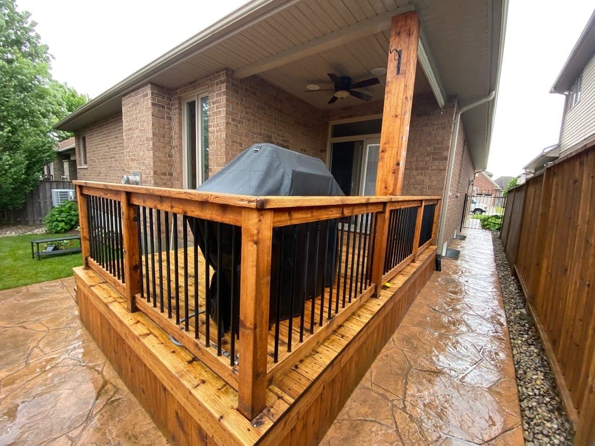 Deck after eco-friendly cleaning, bare wood ready for stain, brick home in Cambridge