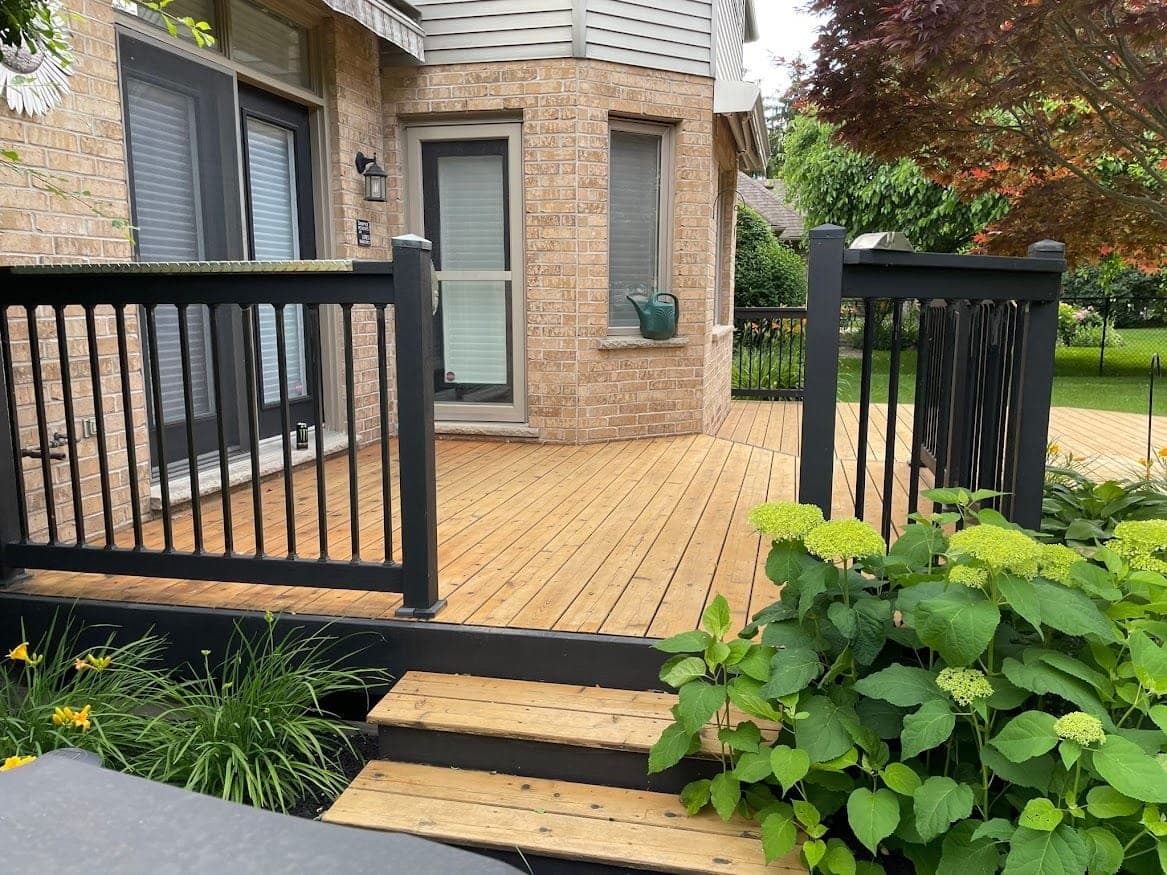 Deck after staining with black railing