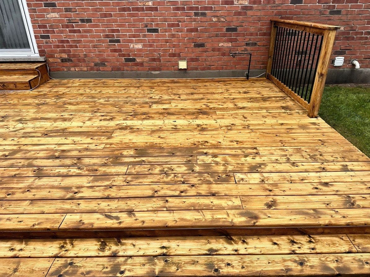Deck cleaning in progress, half cleaned half weathered