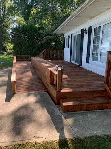 Deck landing and steps after restoration, warm cedar tone