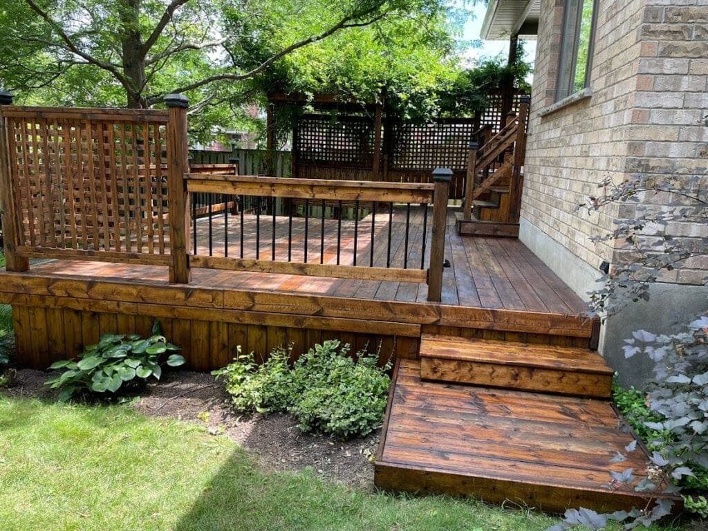 Deck with lattice and garden beds after staining