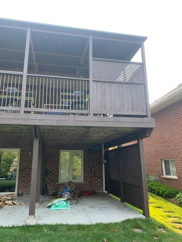Side by side comparison of cedar decking and pressure-treated decking before staining in a Southwestern Ontario backyard