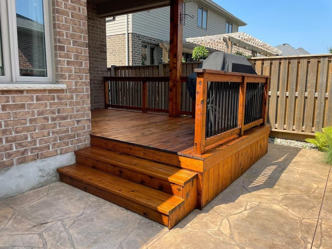 Deck stairs and railing at a brick home