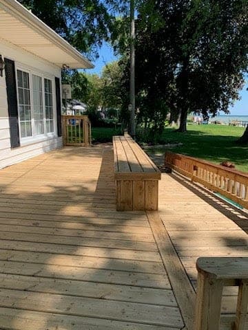 Elevated deck overlooking a lake, cleaned, sanded and restained by Restore My Deck