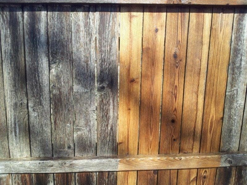 Split view of a fence before and after cleaning