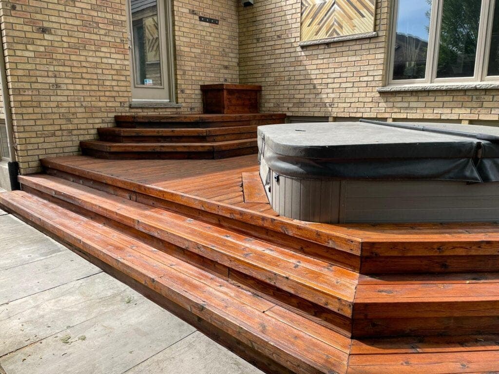 Multi-level deck with hot tub and steps, stained