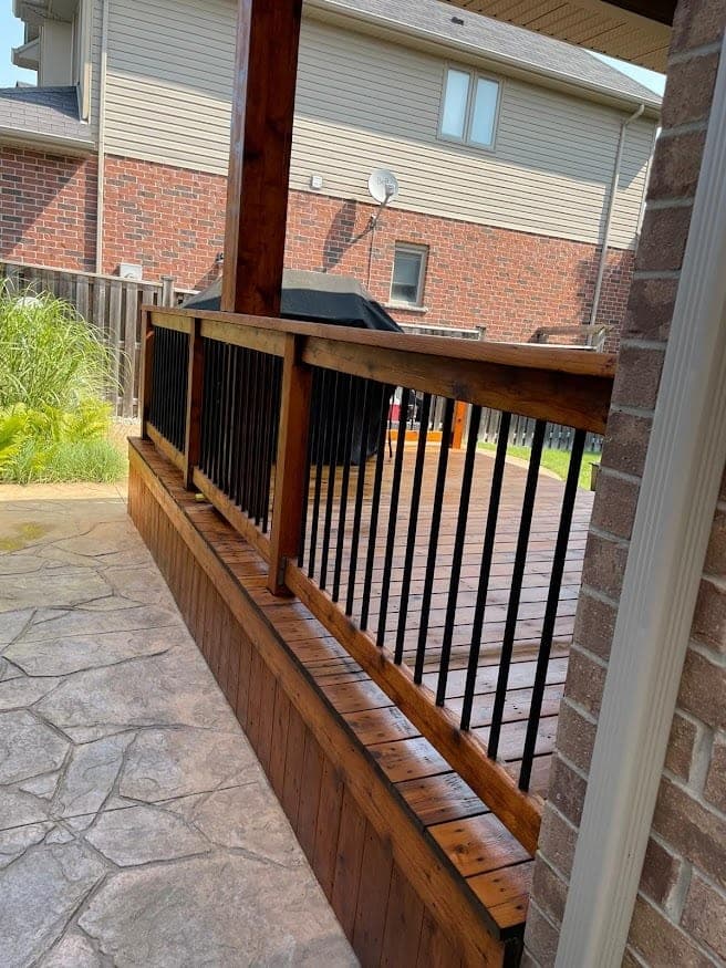 Side-yard privacy fence and deck stained to match